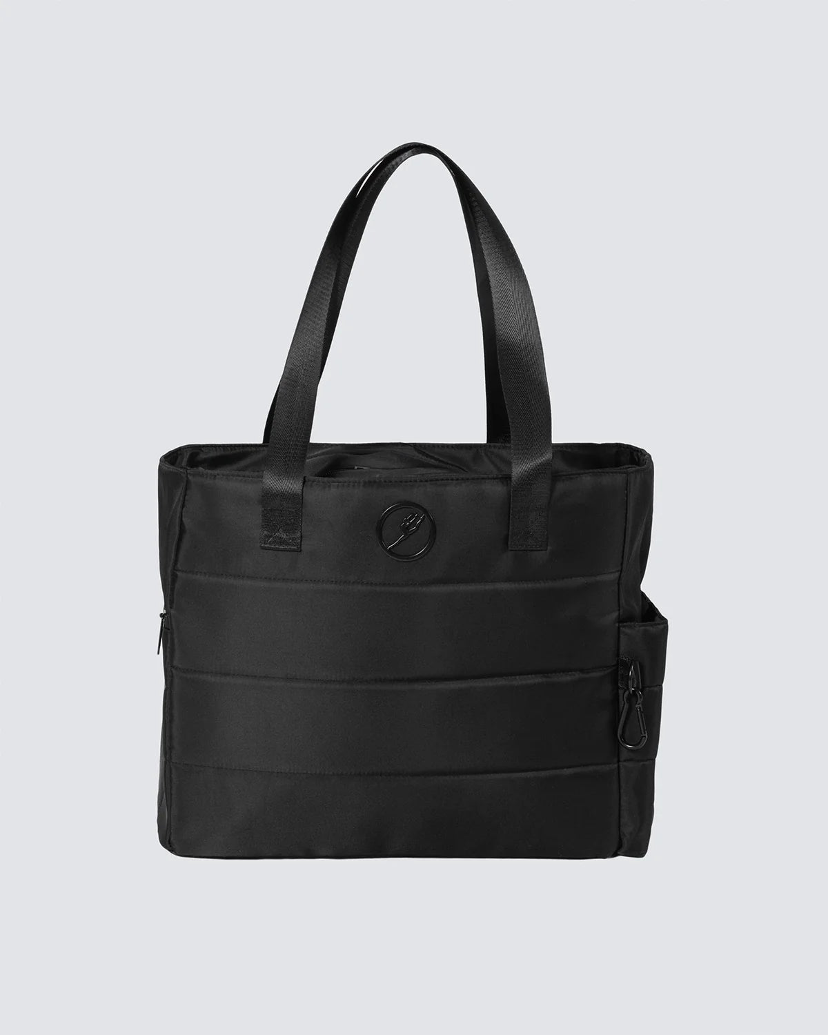 Black tote bag with a visible brand logo on a light gray background